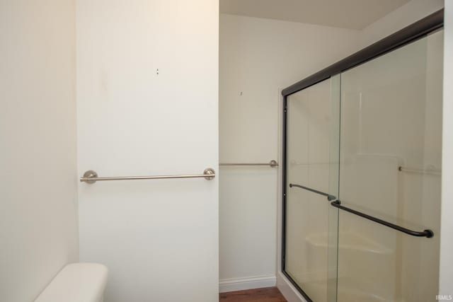12071 W Tecumseh Bend Rd, Brookston, IN 47923 - bathroom with a shower stall, toilet, and wood finished floors