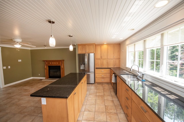 12071 W Tecumseh Bend Rd, Brookston, IN 47923 - kitchen with stainless steel refrigerator with ice dispenser, a sink, plenty of natural light, a fireplace with raised hearth, and ornamental molding