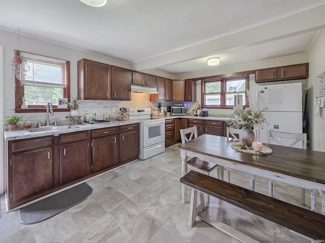 160 SW 5th St, Linton, IN 47441 - kitchen featuring white appliances, a sink, light countertops, under cabinet range hood, and backsplash