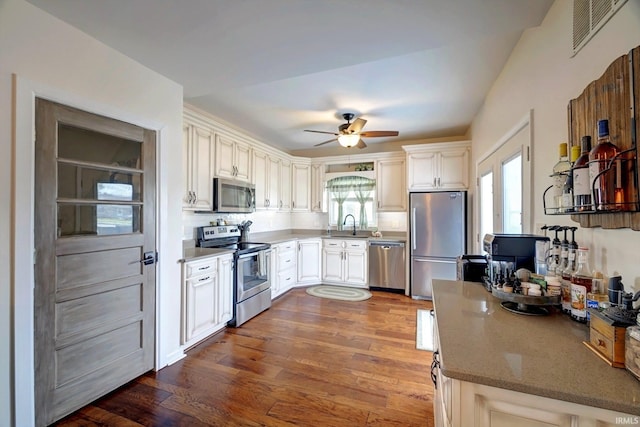 210 W Main St, Worthington, IN 47471 - kitchen with stainless steel appliances, dark wood-style floors, a ceiling fan, a sink, and white cabinets