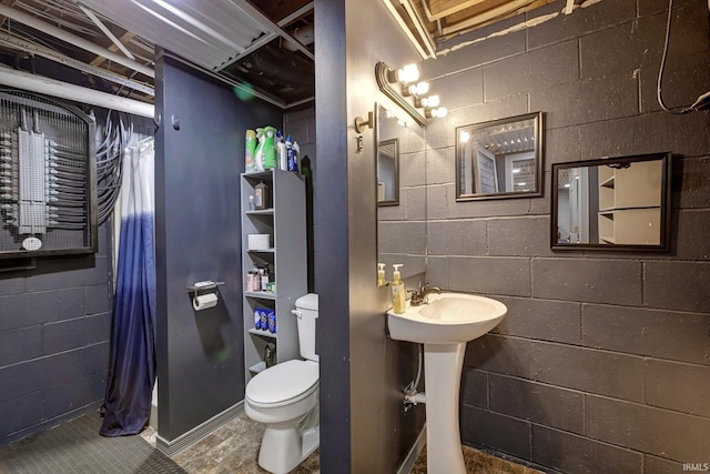 210 W Main St, Worthington, IN 47471 - full bathroom featuring toilet, a shower with curtain, and concrete block wall