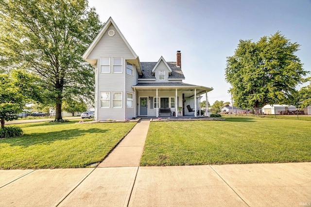 210 W Main St, Worthington, IN 47471 - view of front of home with covered porch, a chimney, and a front yard