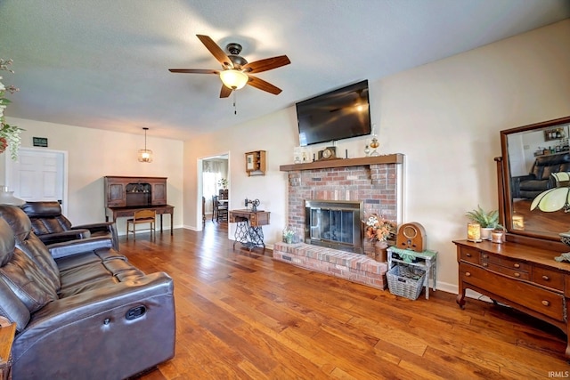 210 W Main St, Worthington, IN 47471 - living room with ceiling fan, a fireplace, and wood finished floors