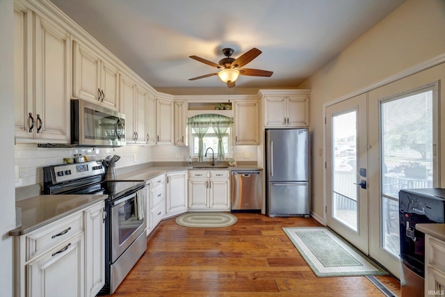 210 W Main St, Worthington, IN 47471 - kitchen with appliances with stainless steel finishes, french doors, tasteful backsplash, ceiling fan, and a sink