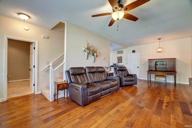 210 W Main St, Worthington, IN 47471 - living area with hardwood / wood-style floors, ceiling fan, stairs, baseboards, and a textured ceiling