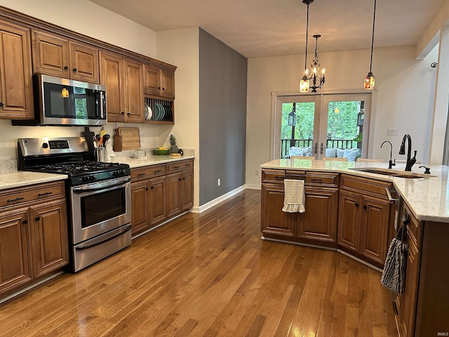 8284 S Mackenzie Ct, Bloomington, IN 47401 - kitchen with appliances with stainless steel finishes, a sink, french doors, and dark wood-style flooring
