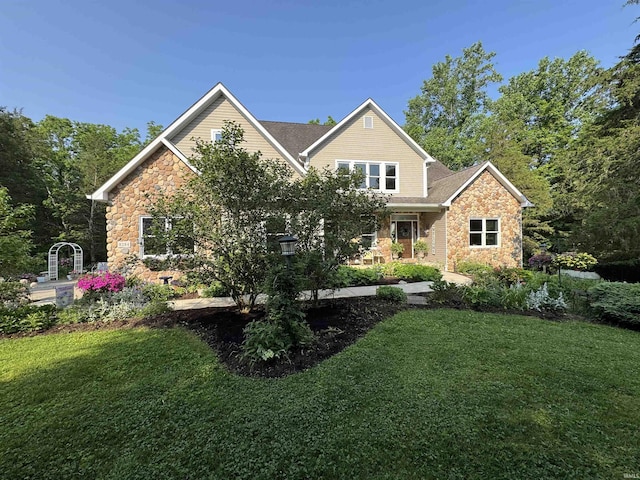 8284 S Mackenzie Ct, Bloomington, IN 47401 - rear view of property featuring stone siding and a lawn
