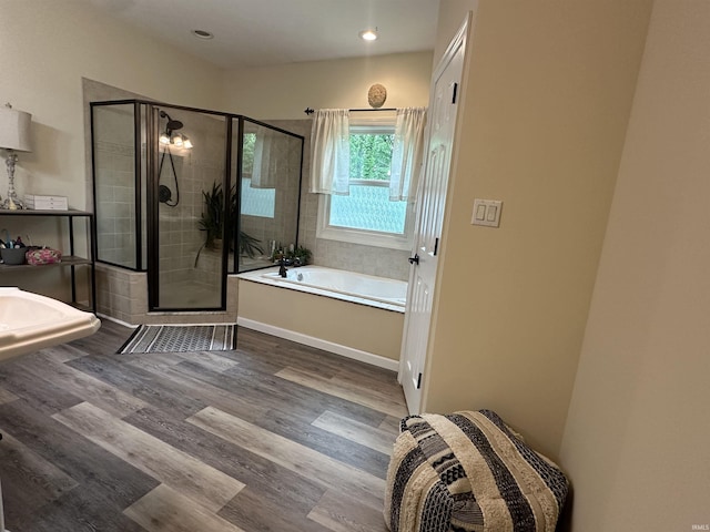 8284 S Mackenzie Ct, Bloomington, IN 47401 - full bathroom featuring a bath, a stall shower, wood finished floors, and recessed lighting