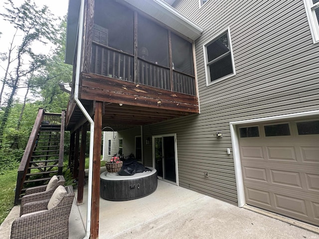 8284 S Mackenzie Ct, Bloomington, IN 47401 - back of property with stairway, a garage, a patio area, and a sunroom