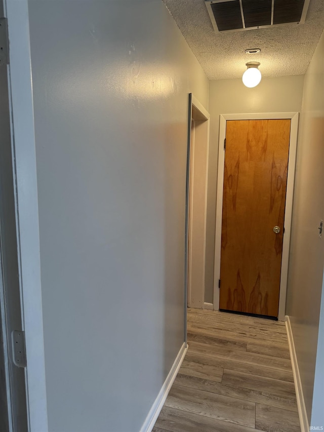 2124 Boulevard St, Rochester, IN 46975 - corridor featuring wood finished floors, a textured ceiling, and baseboards