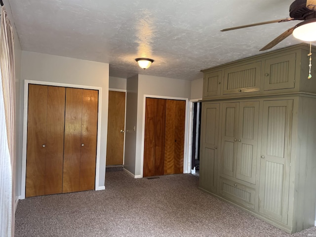 2124 Boulevard St, Rochester, IN 46975 - unfurnished bedroom featuring carpet, multiple closets, baseboards, and a ceiling fan