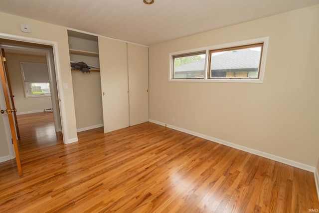 3314 Whitcomb Ave, South Bend, IN 46614 - unfurnished bedroom featuring light wood-type flooring, a closet, and baseboards
