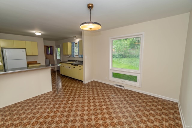 3314 Whitcomb Ave, South Bend, IN 46614 - kitchen featuring freestanding refrigerator, baseboards, dark countertops, and cream cabinets