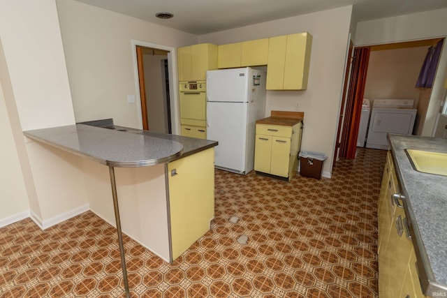 3314 Whitcomb Ave, South Bend, IN 46614 - kitchen featuring freestanding refrigerator, washer and dryer, oven, tile patterned floors, and cream cabinets