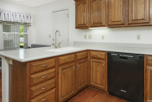 3915 S Allen Ct, Bloomington, IN 47401 - kitchen featuring black dishwasher, a sink, a peninsula, brown cabinets, and light countertops