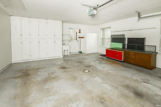 3915 S Allen Ct, Bloomington, IN 47401 - garage featuring a garage door opener and a sink