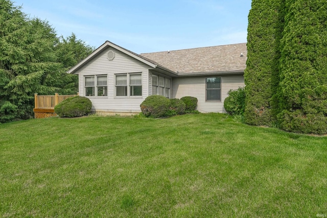 3915 S Allen Ct, Bloomington, IN 47401 - back of house featuring a lawn, a wooden deck, and roof with shingles