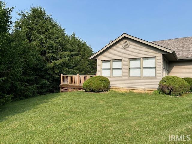 3915 S Allen Ct, Bloomington, IN 47401 - view of side of property with a lawn, a deck, and a shingled roof