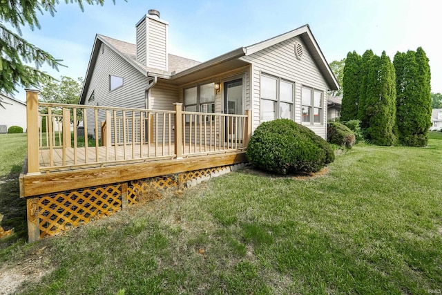 3915 S Allen Ct, Bloomington, IN 47401 - back of house with a chimney, a wooden deck, a lawn, and roof with shingles
