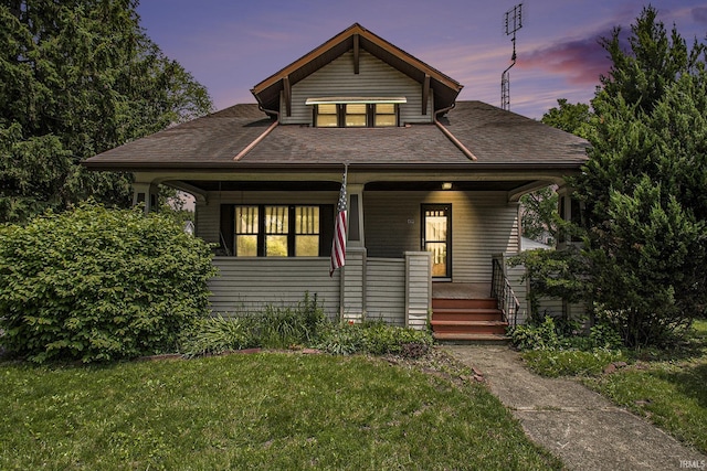 419 S First St, Pierceton, IN 46562 - bungalow with covered porch, a front lawn, and roof with shingles