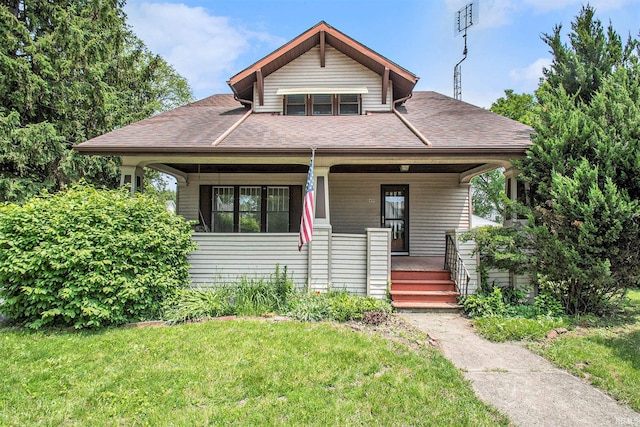 419 S First St, Pierceton, IN 46562 - bungalow-style home featuring covered porch, a front lawn, and roof with shingles