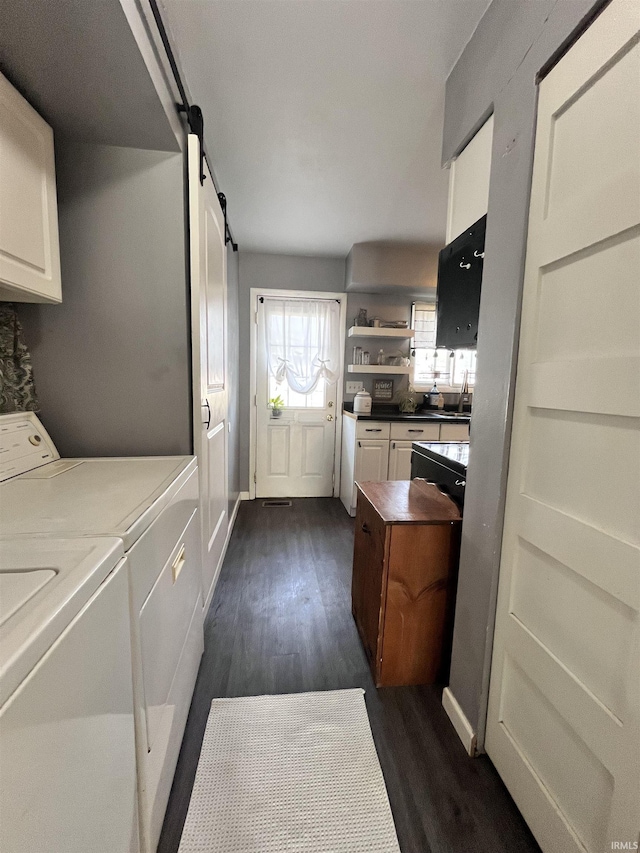 1818 N Indiana Ave, Kokomo, IN 46901 - laundry room featuring washing machine and clothes dryer, dark wood-style floors, and a barn door