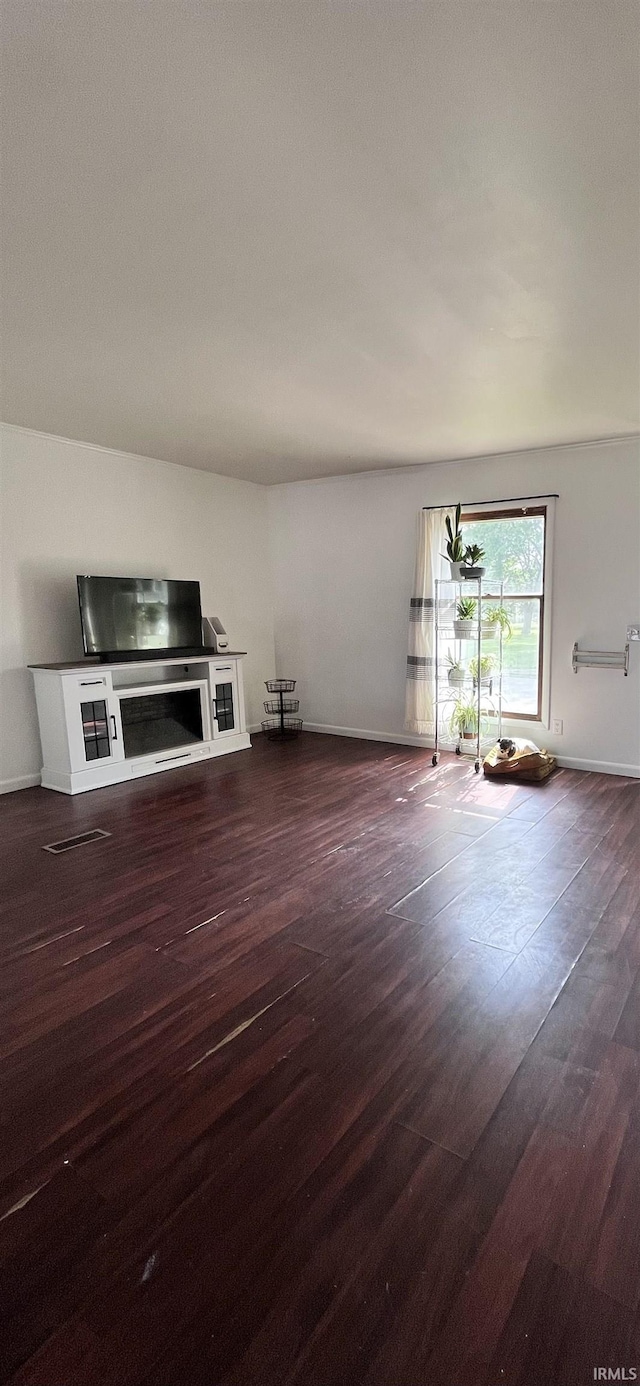 1818 N Indiana Ave, Kokomo, IN 46901 - unfurnished living room featuring wood finished floors and baseboards