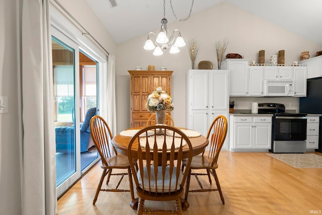 2410 Deerfield Ct, Decatur, IN 46733 - dining room with vaulted ceiling, a chandelier, and light wood-style floors