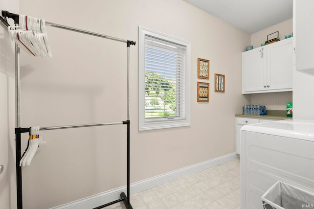 2410 Deerfield Ct, Decatur, IN 46733 - washroom with cabinet space, baseboards, washer / dryer, and light floors