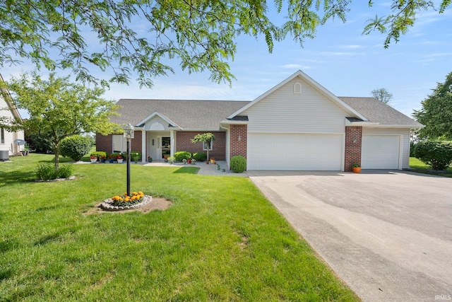 2410 Deerfield Ct, Decatur, IN 46733 - ranch-style home with an attached garage, driveway, a front lawn, and brick siding