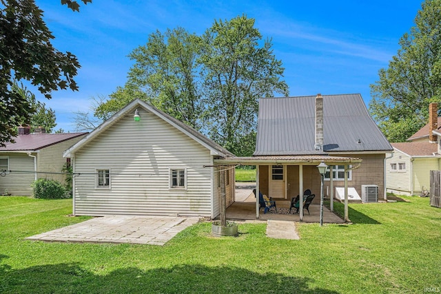 773 N E St, Wabash, IN 46992 - back of property with a patio area, a lawn, central air condition unit, and metal roof