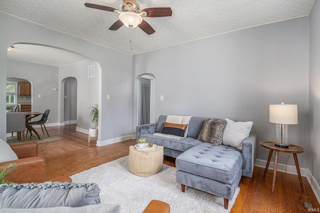 773 N E St, Wabash, IN 46992 - living area with arched walkways, ceiling fan, wood finished floors, baseboards, and ornamental molding