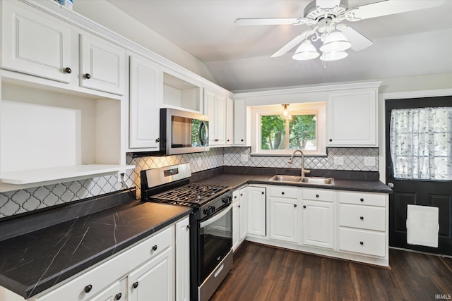819 S 8th St, Goshen, IN 46526 - kitchen featuring stainless steel appliances, a sink, dark countertops, dark wood finished floors, and white cabinets