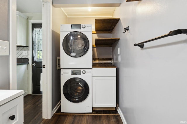 819 S 8th St, Goshen, IN 46526 - laundry room with stacked washer / dryer, cabinet space, dark wood-type flooring, and baseboards