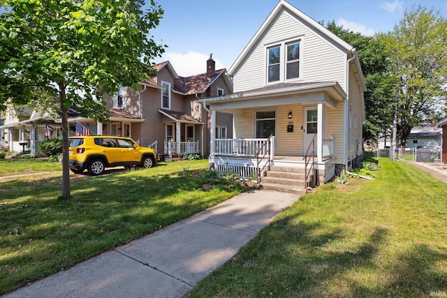 819 S 8th St, Goshen, IN 46526 - view of front of house featuring a porch and a front lawn