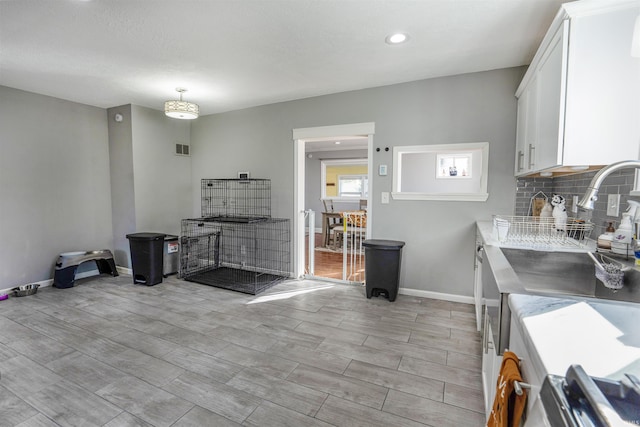 104 N Jefferson St, Pine Village, IN 47975 - kitchen featuring white cabinetry, light countertops, baseboards, recessed lighting, and backsplash