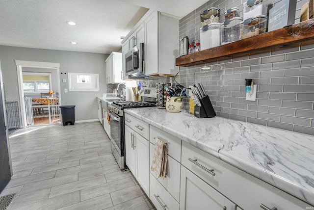 104 N Jefferson St, Pine Village, IN 47975 - kitchen with appliances with stainless steel finishes, backsplash, baseboards, light stone counters, and recessed lighting