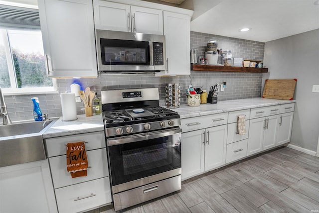 104 N Jefferson St, Pine Village, IN 47975 - kitchen with stainless steel appliances, tasteful backsplash, white cabinetry, light wood-style flooring, and recessed lighting