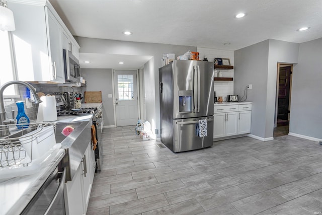 104 N Jefferson St, Pine Village, IN 47975 - kitchen with stainless steel appliances, baseboards, backsplash, white cabinetry, and recessed lighting