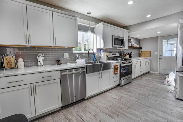 104 N Jefferson St, Pine Village, IN 47975 - kitchen with appliances with stainless steel finishes, backsplash, a sink, light wood finished floors, and recessed lighting