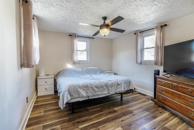 104 N Jefferson St, Pine Village, IN 47975 - bedroom featuring wood finished floors, baseboards, a textured ceiling, and a ceiling fan