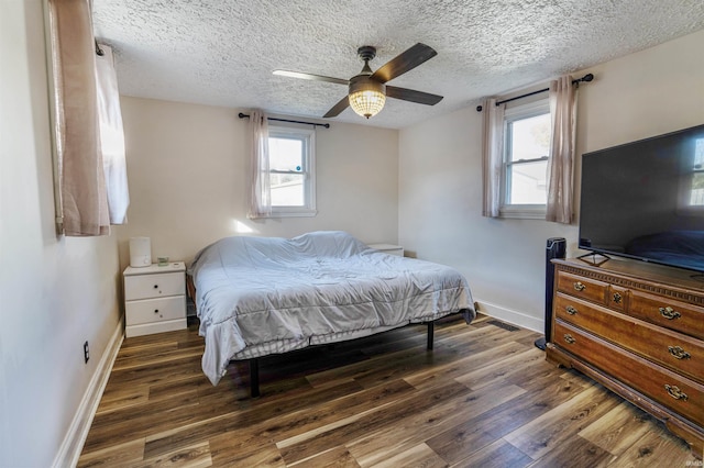 104 N Jefferson St, Pine Village, IN 47975 - bedroom featuring baseboards, wood finished floors, a textured ceiling, and ceiling fan