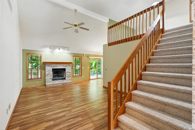 6115 Catbird Ave, Fort Wayne, IN 46818 - unfurnished living room with wood finished floors, stairway, healthy amount of natural light, ceiling fan, and high vaulted ceiling