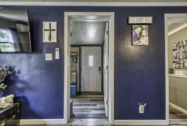 1439 W Central Ave, Bluffton, IN 46714 - entrance foyer featuring wood finished floors, baseboards, and crown molding