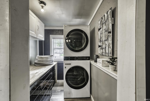 1439 W Central Ave, Bluffton, IN 46714 - laundry area with stacked washer and clothes dryer, cabinet space, and wood finished floors