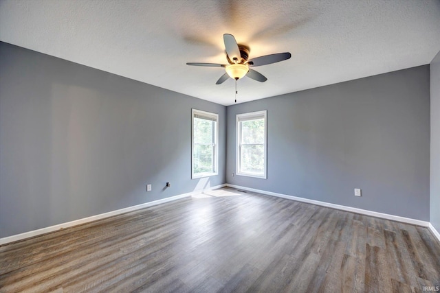1063 S Colchester Ct, Bloomington, IN 47401 - spare room featuring wood finished floors, ceiling fan, baseboards, and a textured ceiling