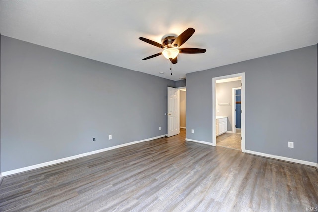 1063 S Colchester Ct, Bloomington, IN 47401 - unfurnished bedroom with baseboards, wood finished floors, ensuite bathroom, and a ceiling fan