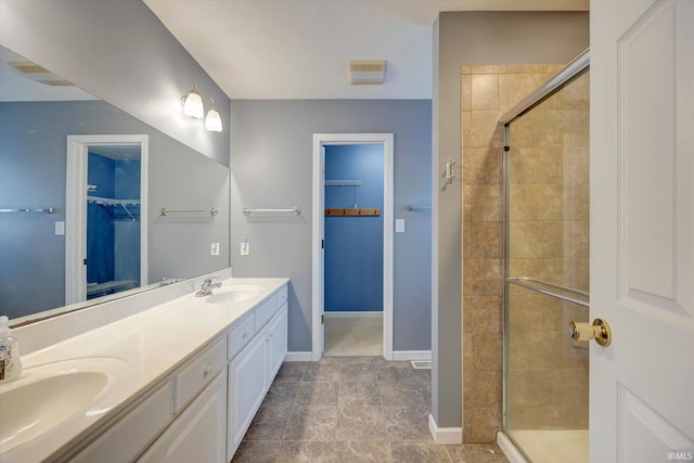 1063 S Colchester Ct, Bloomington, IN 47401 - full bath featuring a spacious closet, double vanity, a stall shower, and baseboards