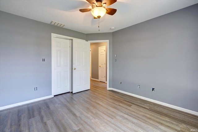 1063 S Colchester Ct, Bloomington, IN 47401 - unfurnished bedroom featuring baseboards, wood finished floors, a closet, and ceiling fan