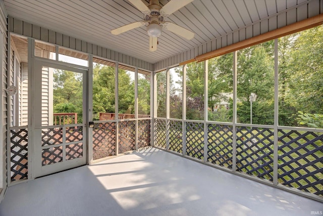 1063 S Colchester Ct, Bloomington, IN 47401 - unfurnished sunroom with a ceiling fan and view of wooded area